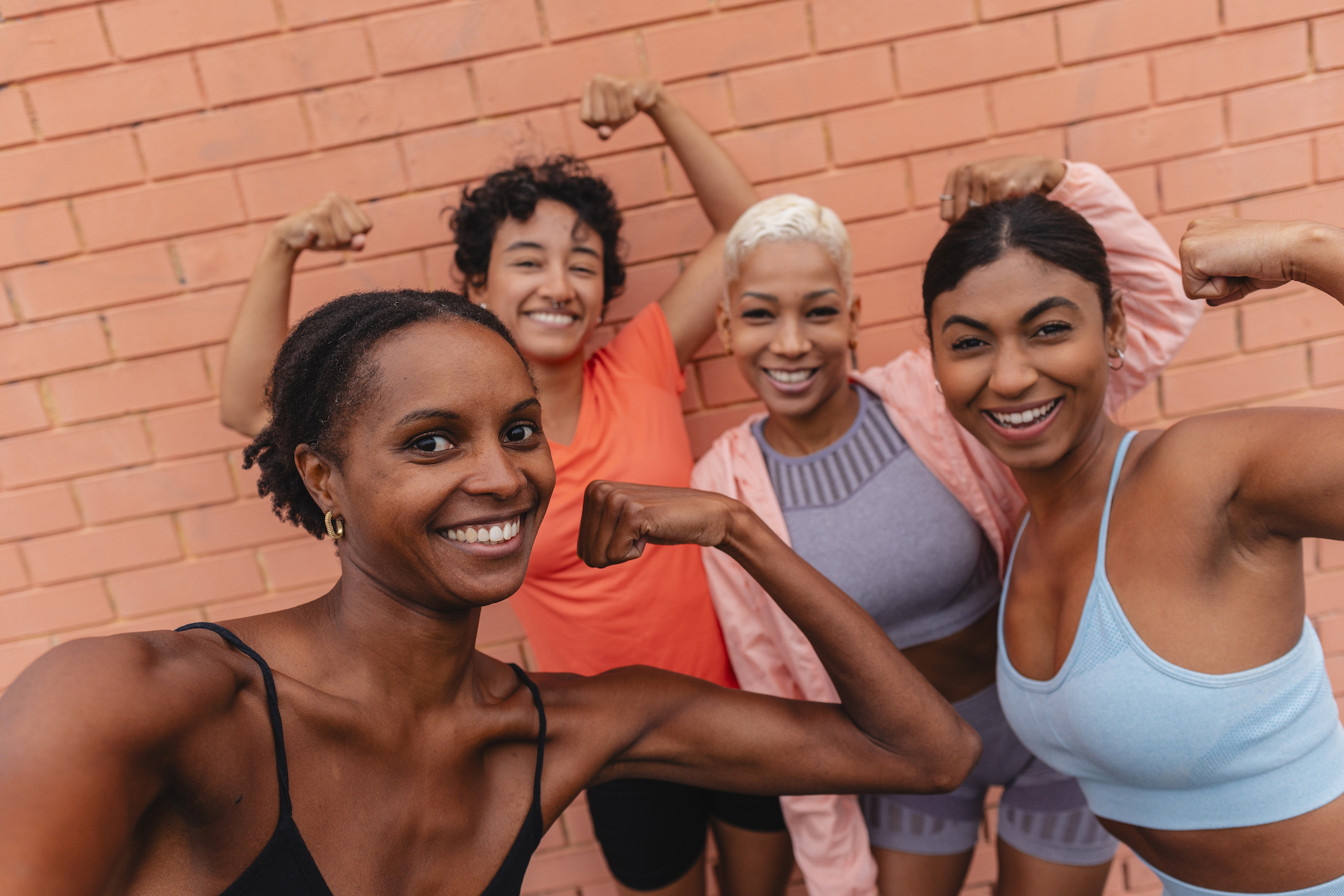 Four joyful women celebrating together